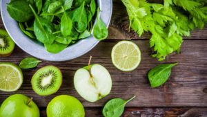 Green healthy vegetables and fruit on wood table