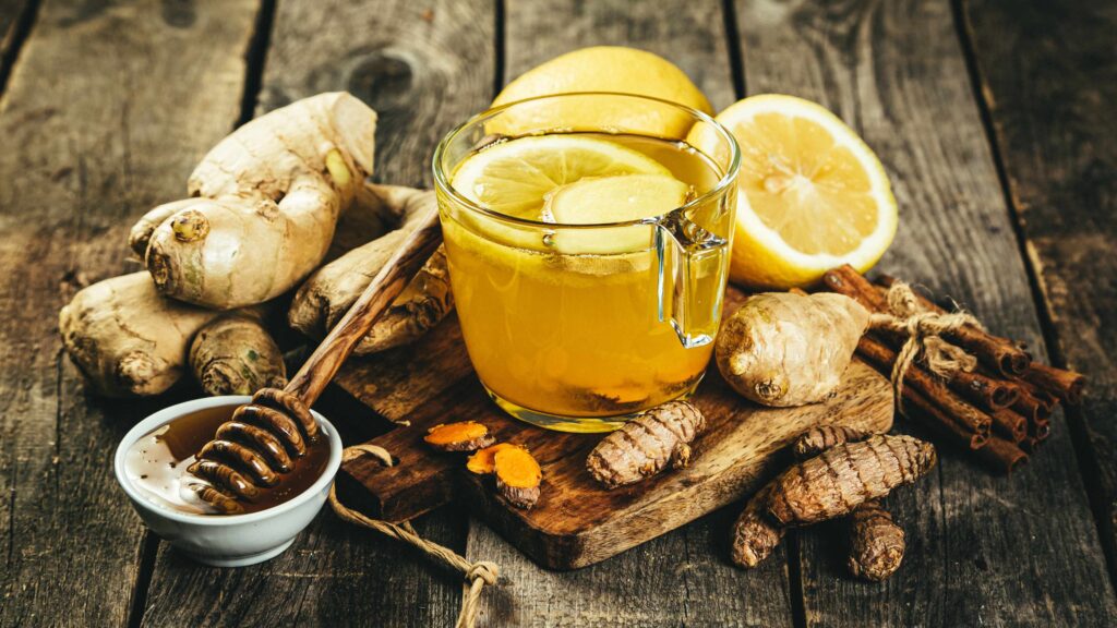Honey, ginger, turmeric and tea on a wooden table
