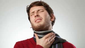 Man with sore throat because of vocal damage